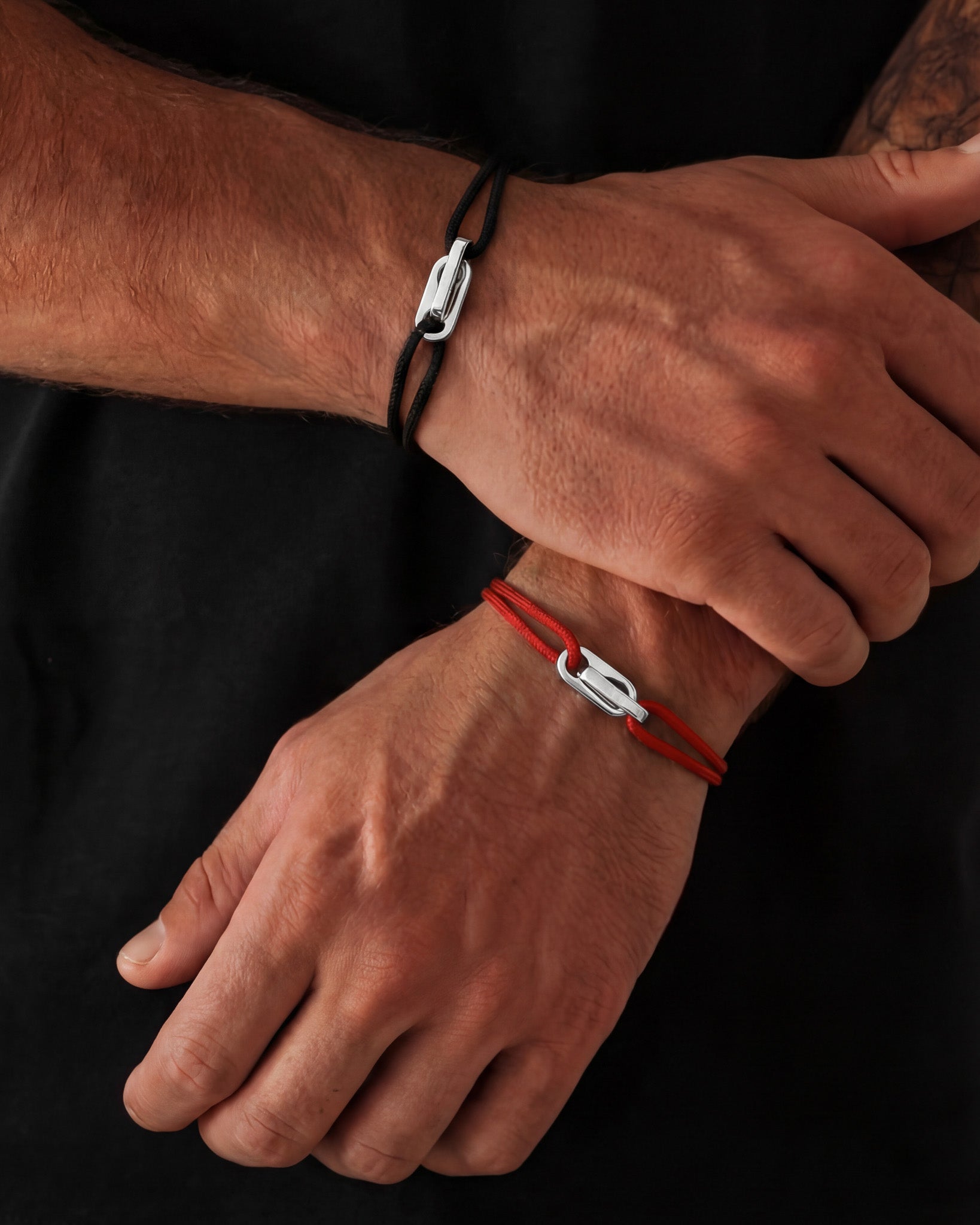Atlantis silver bracelet with black cord and adjustable clasp on wrist
