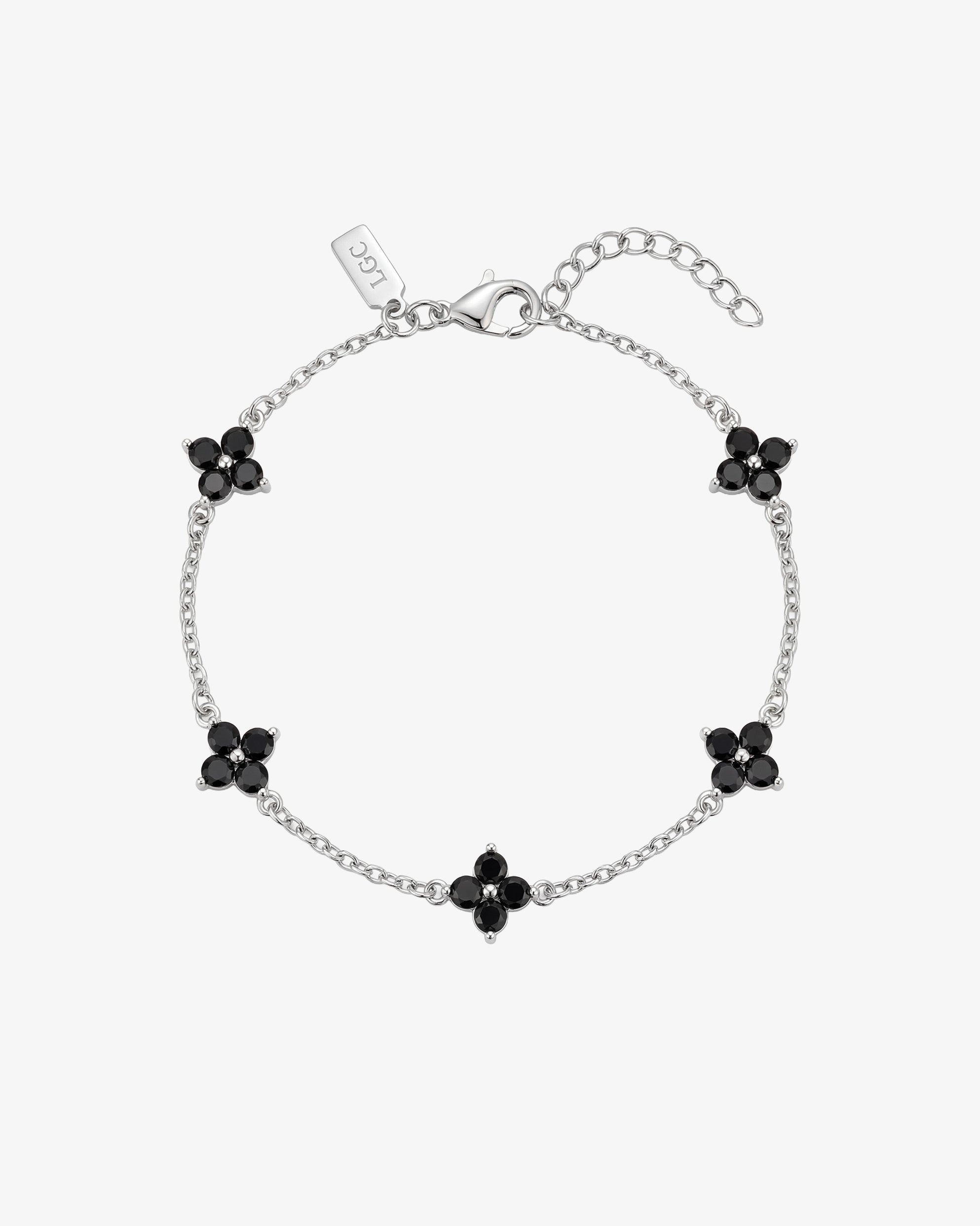 Silver Clover bracelet with black gemstone flower charms along a delicate chain