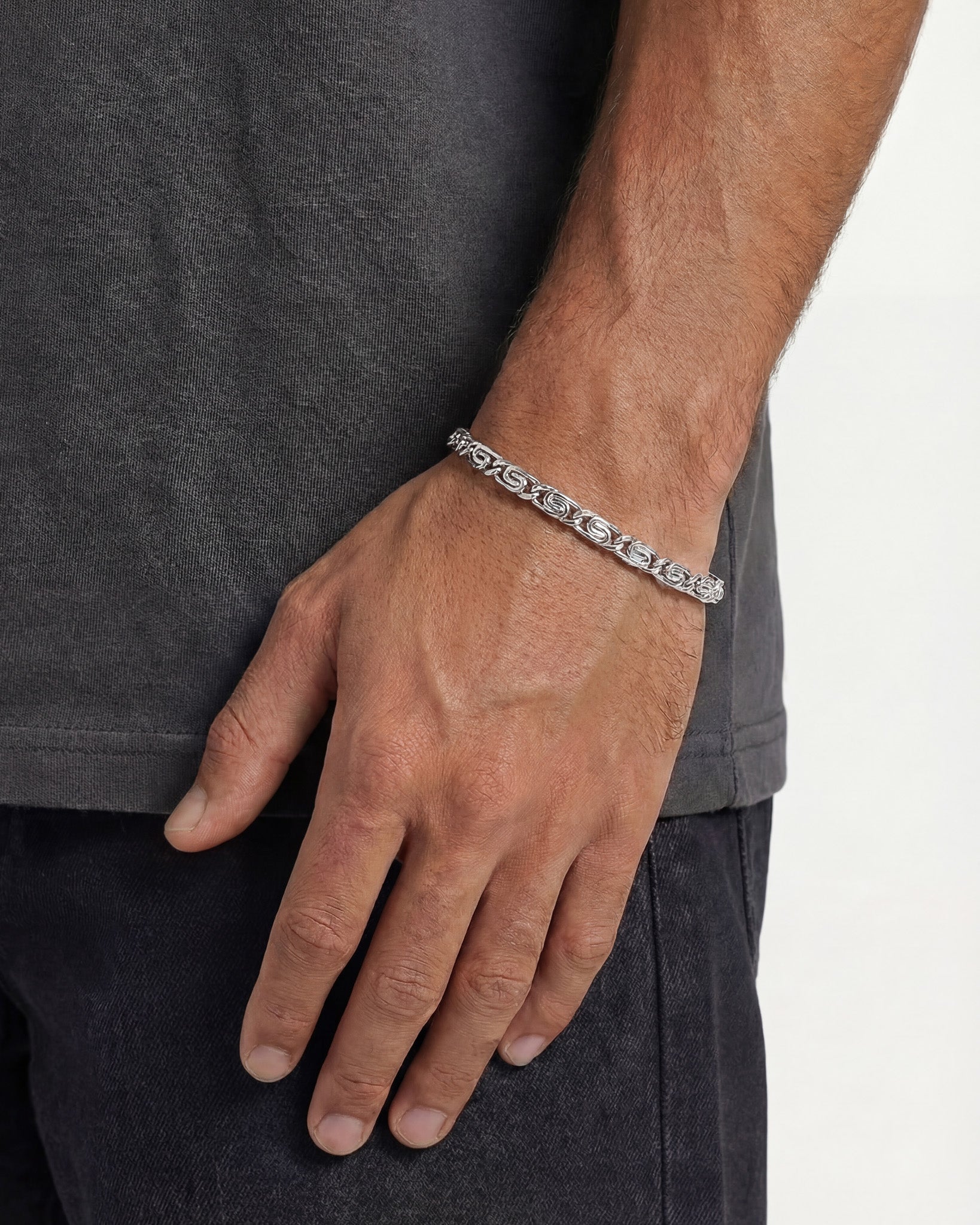 NUSA SILVER BRACELET worn on a man's wrist showing a bold linked pattern