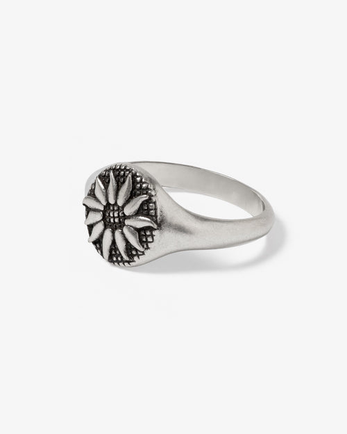 Fleur Silver Ring close up showing a flower motif on a smooth silver band