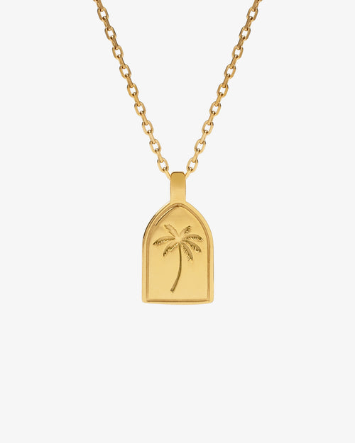 Gold palm tree pendant on a simple chain necklace
