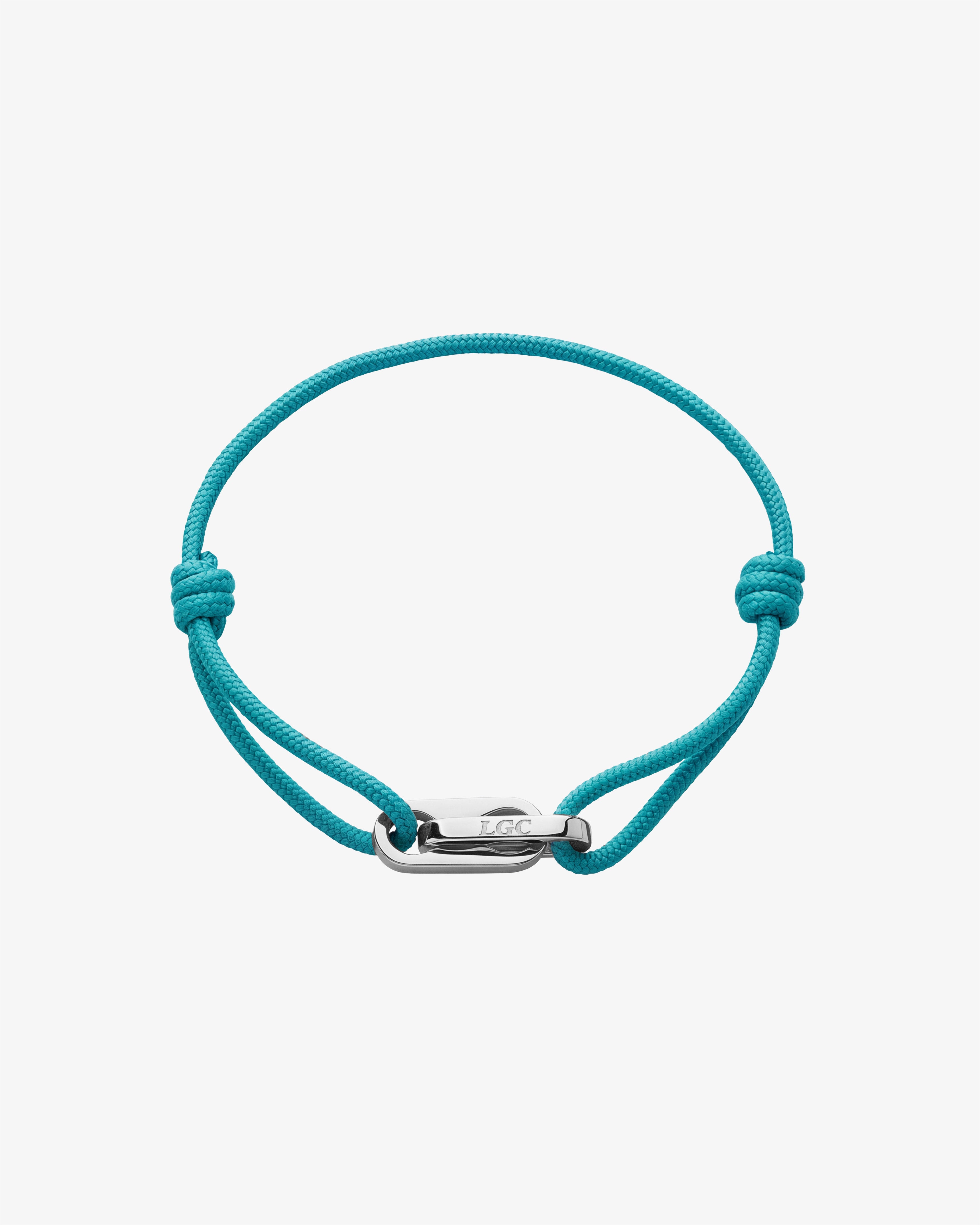Pulsera plateada Atlantis con cordón trenzado turquesa y cierre metálico