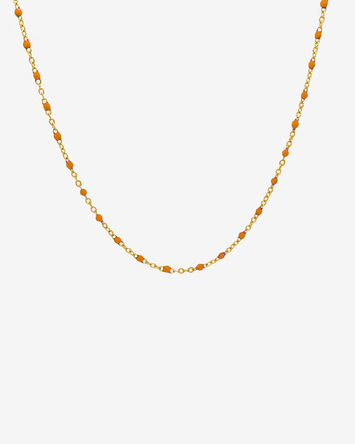 GEM gold chain necklace with orange beads spaced along a delicate gold link chain on white background