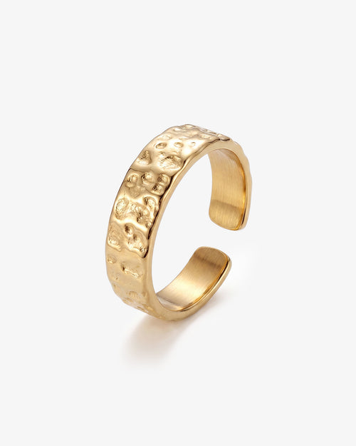 Hammered gold 6mm ring with textured surface on a man's finger.