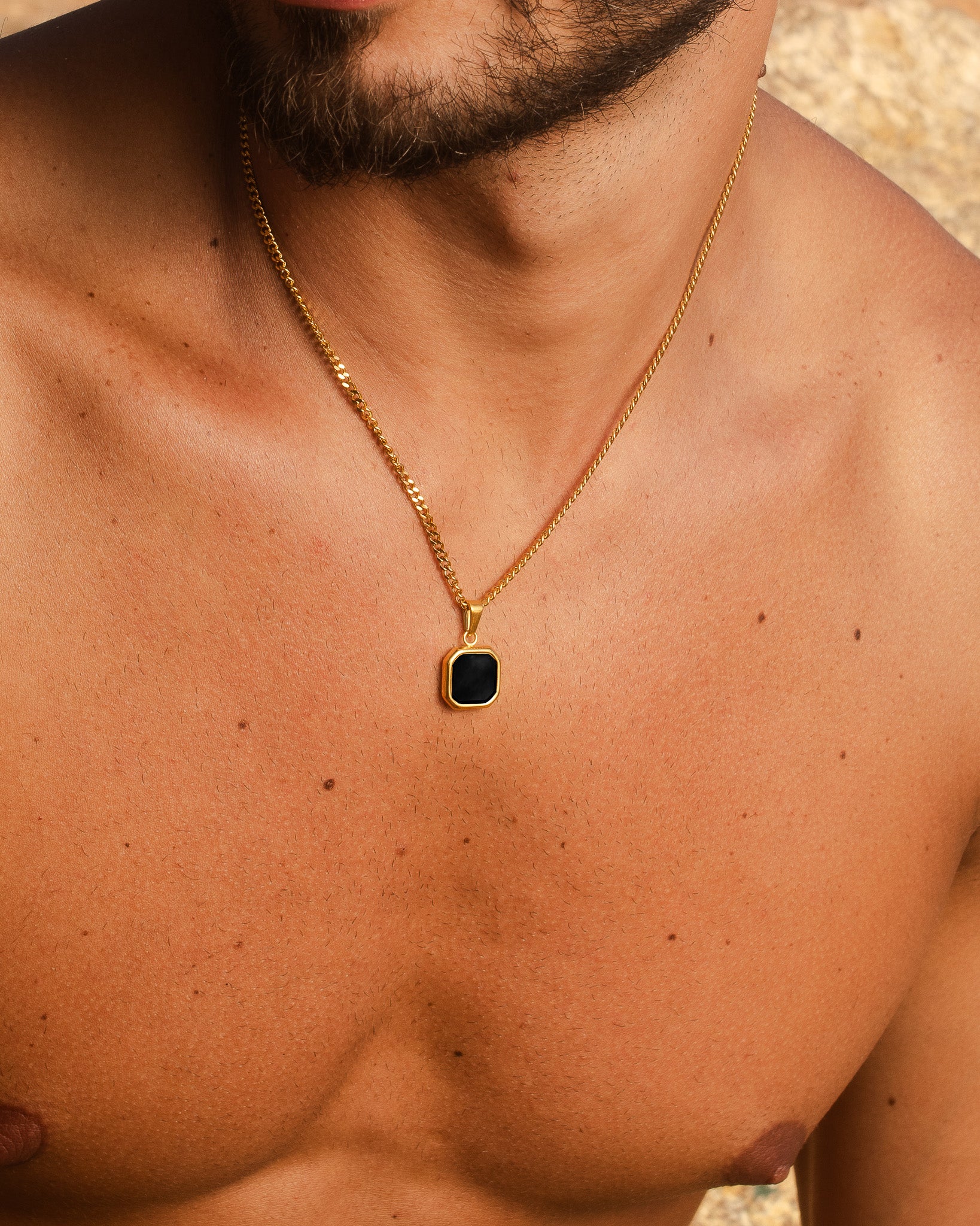 Nova Gold necklace shown from a different angle with the square black pendant at the chest