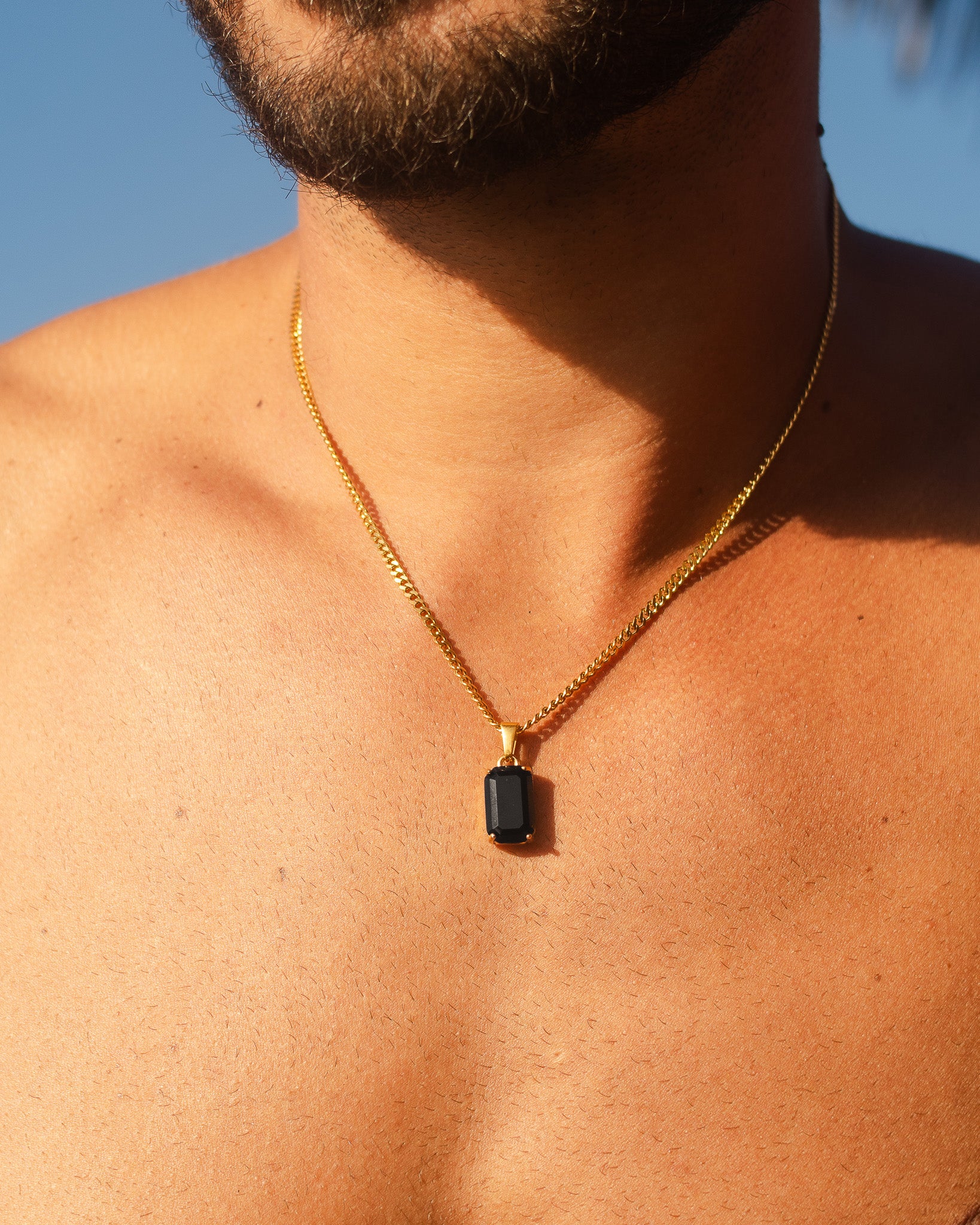 VOLT gold necklace worn on the neck with a close up of the chain